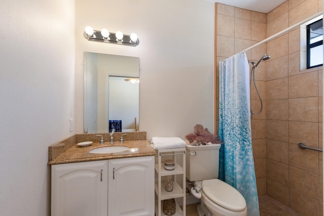 bathroom featuring a tile shower, toilet, and vanity