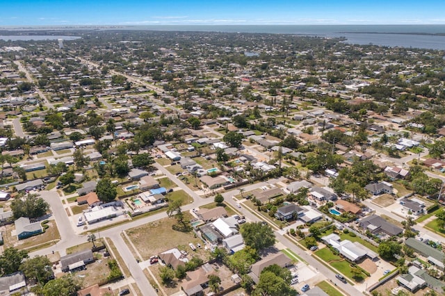 aerial view of property and surrounding area featuring a large body of water