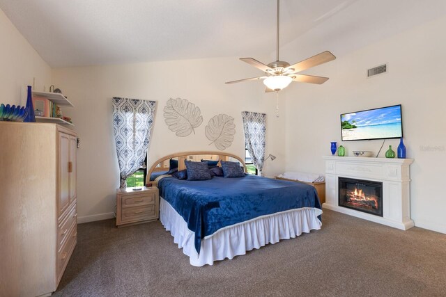 5403 2nd Ave W, Bradenton, FL 34209 - bedroom with vaulted ceiling, carpet floors, a glass covered fireplace, ceiling fan, and baseboards