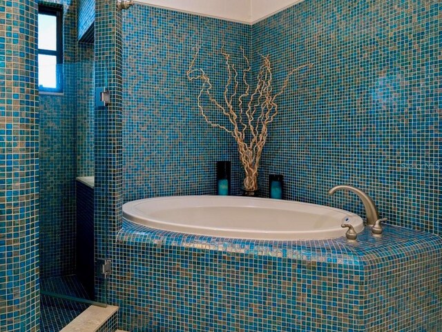 5403 2nd Ave W, Bradenton, FL 34209 - full bathroom featuring a garden tub, a tile shower, and tile walls
