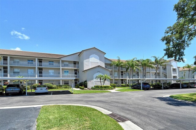 8735 Olde Hickory Ave Unit 8205, Sarasota, FL 34238 - view of property featuring covered and uncovered parking