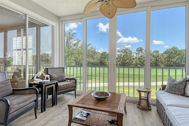 8735 Olde Hickory Ave Unit 8205, Sarasota, FL 34238 - sunroom featuring a ceiling fan, outdoor lounge area, and view of wooded area