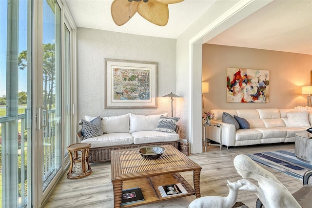 8735 Olde Hickory Ave Unit 8205, Sarasota, FL 34238 - living area with plenty of natural light, light wood-style flooring, ceiling fan, and a textured wall