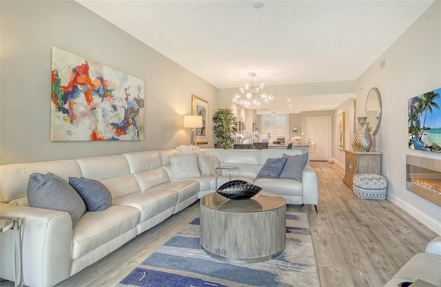 8735 Olde Hickory Ave Unit 8205, Sarasota, FL 34238 - living area featuring light wood-style floors, a chandelier, and baseboards