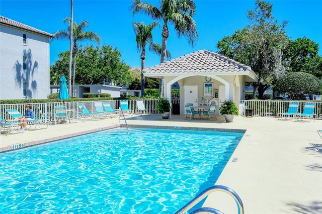 8735 Olde Hickory Ave Unit 8205, Sarasota, FL 34238 - community pool with fence, a patio, and an outbuilding