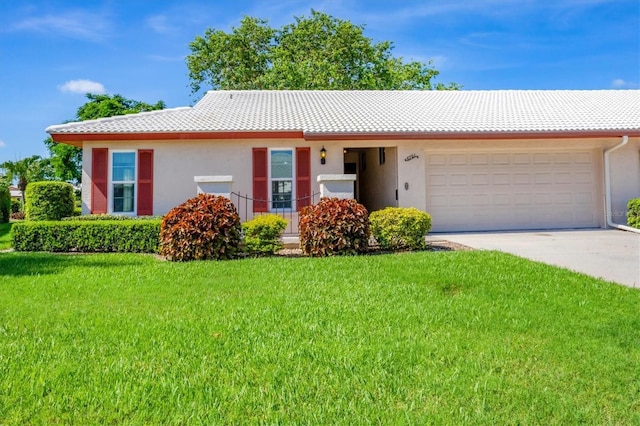 6701 12th Ave W, Bradenton, FL 34209 - view of front of house with an attached garage, driveway, a front lawn, and stucco siding