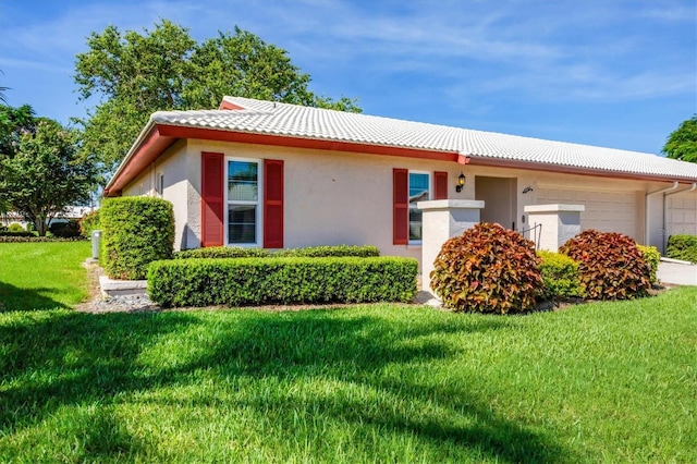 6701 12th Ave W, Bradenton, FL 34209 - view of front of house featuring a tiled roof, an attached garage, a front yard, and stucco siding