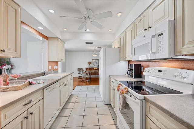 6701 12th Ave W, Bradenton, FL 34209 - kitchen featuring white appliances, cream cabinets, light countertops, light tile patterned floors, and recessed lighting