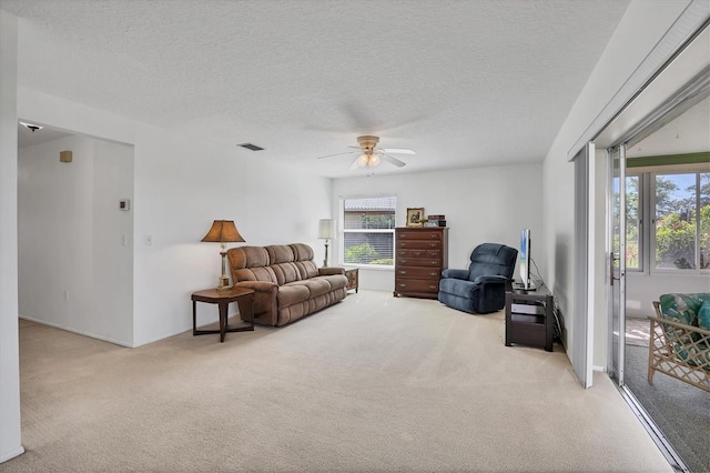 6701 12th Ave W, Bradenton, FL 34209 - living room with carpet floors, plenty of natural light, ceiling fan, and a textured ceiling