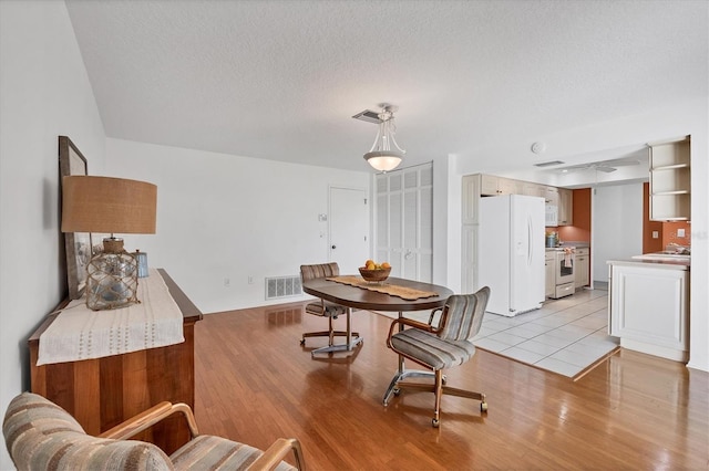 6701 12th Ave W, Bradenton, FL 34209 - dining space featuring light wood-style floors and a textured ceiling