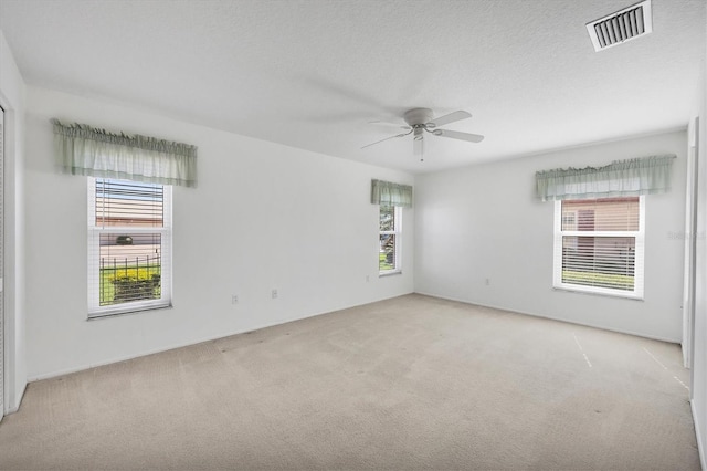 6701 12th Ave W, Bradenton, FL 34209 - unfurnished room featuring light carpet, plenty of natural light, and a ceiling fan