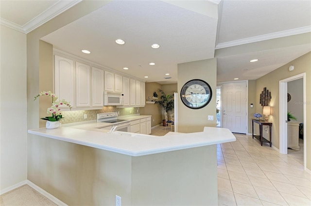8422 Wethersfield Run Unit 103, Lakewood Ranch, FL 34202 - kitchen featuring white appliances, backsplash, light countertops, recessed lighting, and light tile patterned flooring