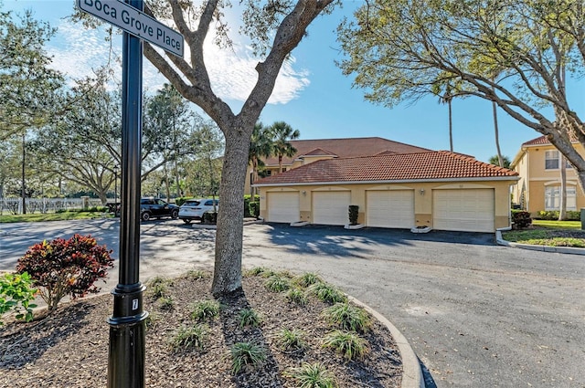 8422 Wethersfield Run Unit 103, Lakewood Ranch, FL 34202 - view of side of home featuring a tiled roof and stucco siding
