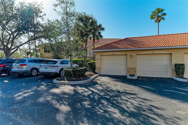 8422 Wethersfield Run Unit 103, Lakewood Ranch, FL 34202 - view of side of home featuring stucco siding and a tiled roof