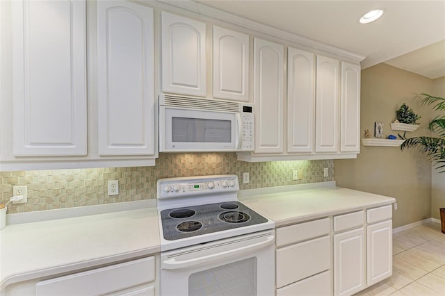 8422 Wethersfield Run Unit 103, Lakewood Ranch, FL 34202 - kitchen with white appliances, light countertops, light tile patterned flooring, white cabinets, and recessed lighting