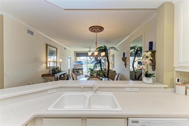 8422 Wethersfield Run Unit 103, Lakewood Ranch, FL 34202 - kitchen featuring a sink, white dishwasher, a chandelier, crown molding, and light countertops