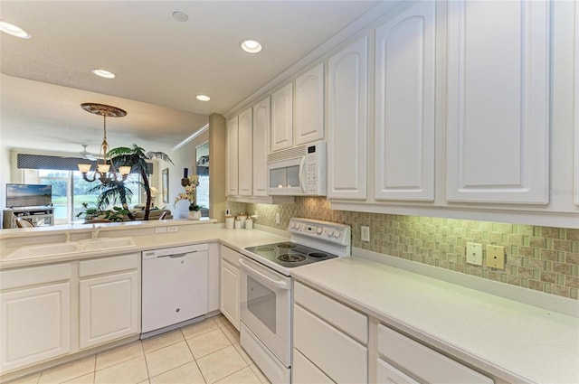 8422 Wethersfield Run Unit 103, Lakewood Ranch, FL 34202 - kitchen featuring white appliances, a chandelier, light tile patterned flooring, light countertops, and a sink