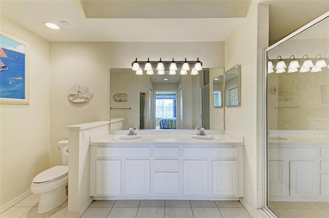 8422 Wethersfield Run Unit 103, Lakewood Ranch, FL 34202 - bathroom with tile patterned floors, toilet, a stall shower, and double vanity