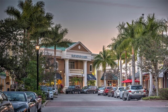 8422 Wethersfield Run Unit 103, Lakewood Ranch, FL 34202 - property at dusk featuring uncovered parking
