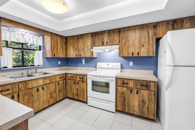 3934 Brookside Dr, Sarasota, FL 34231 - kitchen featuring white appliances, under cabinet range hood, a sink, light countertops, and brown cabinetry