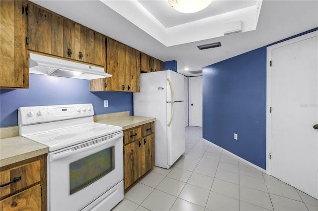 3934 Brookside Dr, Sarasota, FL 34231 - kitchen with white appliances, under cabinet range hood, brown cabinetry, and light countertops