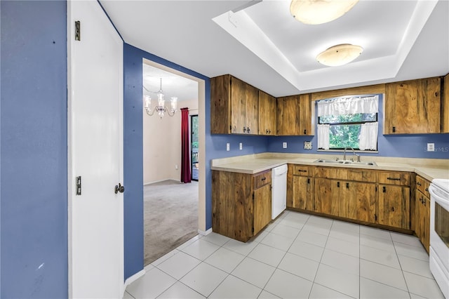 3934 Brookside Dr, Sarasota, FL 34231 - kitchen featuring a sink, dishwasher, light countertops, a chandelier, and brown cabinets