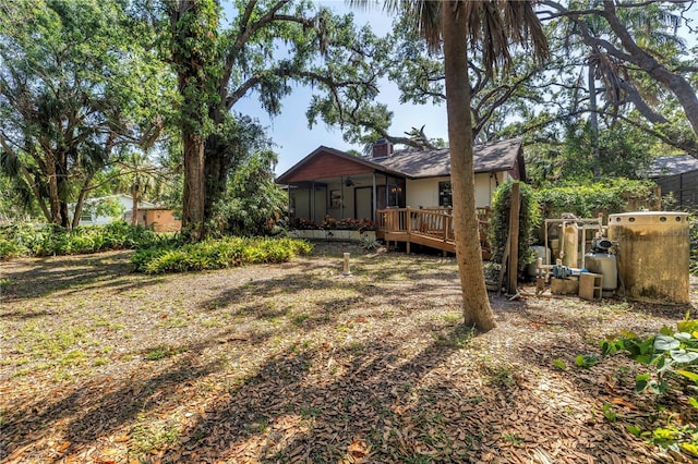 3934 Brookside Dr, Sarasota, FL 34231 - back of house with a sunroom and a wooden deck