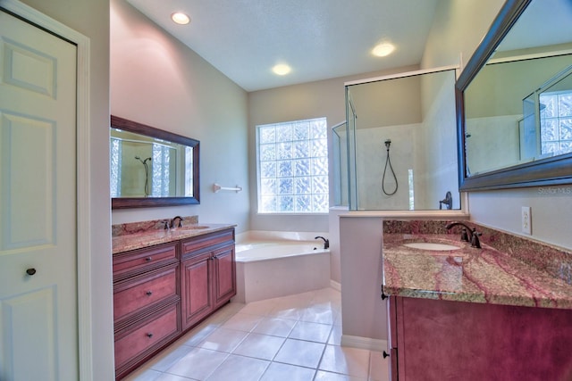 2809 112th Ter E, Parrish, FL 34219 - full bathroom with tile patterned floors, a shower stall, a bath, two vanities, and recessed lighting
