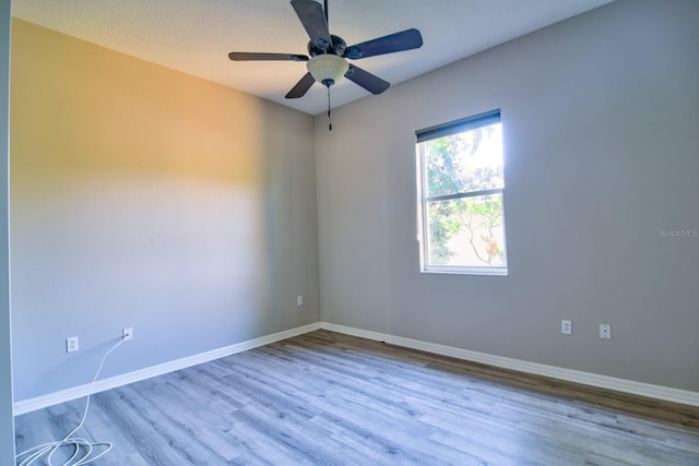 2809 112th Ter E, Parrish, FL 34219 - unfurnished room featuring wood finished floors, baseboards, and ceiling fan