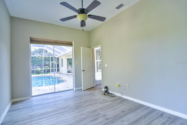 2809 112th Ter E, Parrish, FL 34219 - empty room featuring wood finished floors, baseboards, vaulted ceiling, a sunroom, and ceiling fan