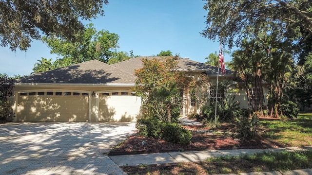 2809 112th Ter E, Parrish, FL 34219 - obstructed view of property featuring decorative driveway, a garage, and a shingled roof