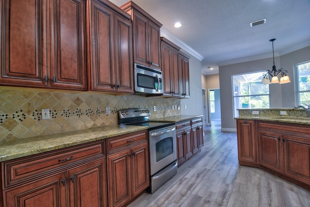 2809 112th Ter E, Parrish, FL 34219 - kitchen with stainless steel appliances, a sink, a chandelier, light wood-type flooring, and decorative backsplash