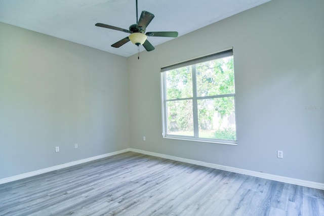 2809 112th Ter E, Parrish, FL 34219 - unfurnished room with wood finished floors, baseboards, and ceiling fan