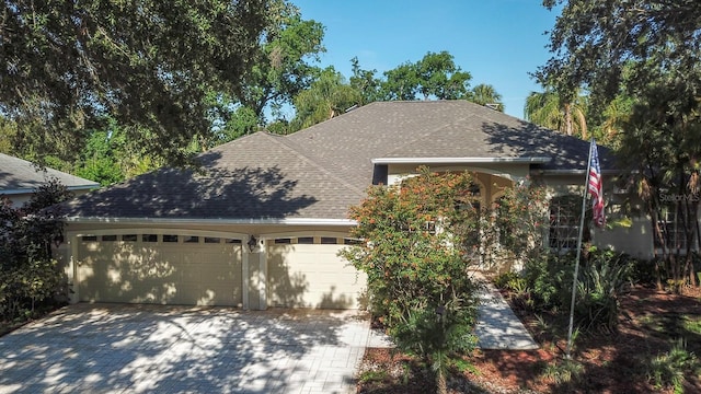2809 112th Ter E, Parrish, FL 34219 - view of front of house featuring an attached garage, roof with shingles, and driveway