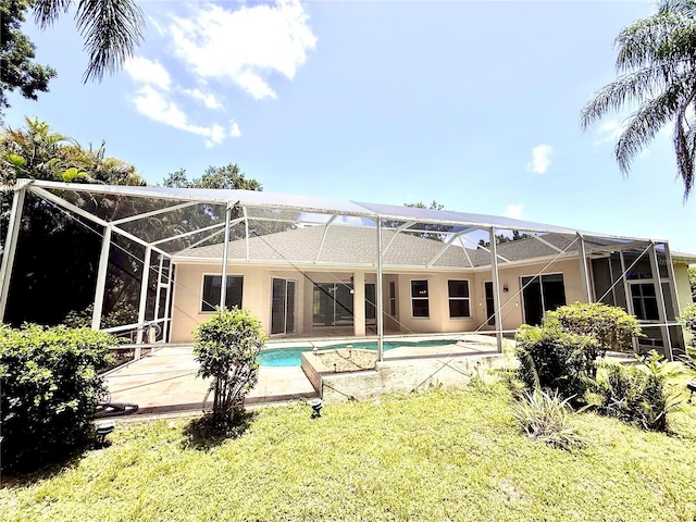 2809 112th Ter E, Parrish, FL 34219 - back of property with glass enclosure, an outdoor pool, stucco siding, and a patio area