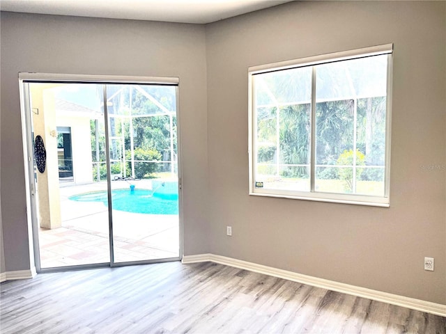 2809 112th Ter E, Parrish, FL 34219 - unfurnished room with wood finished floors and healthy amount of natural light
