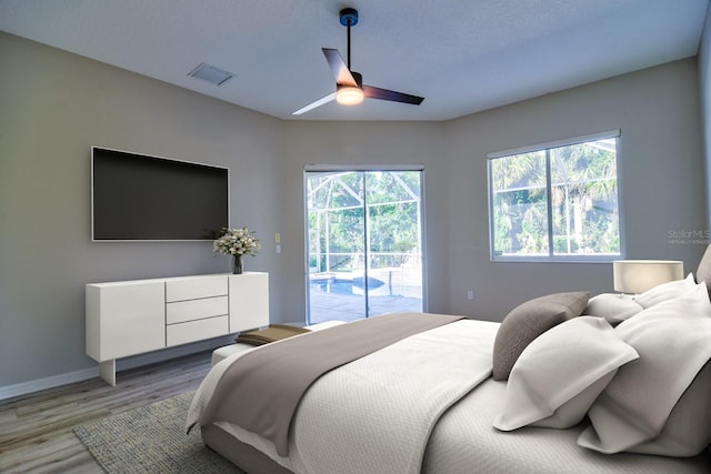 2809 112th Ter E, Parrish, FL 34219 - bedroom featuring access to outside, light wood-style floors, and a ceiling fan