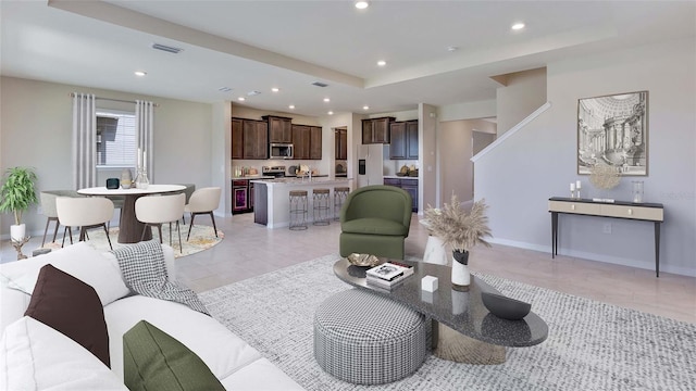living room featuring recessed lighting, baseboards, and light tile patterned floors