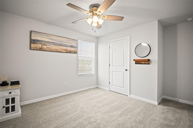 3108 Rock Sound St, Bradenton, FL 34208 - unfurnished bedroom featuring light carpet, baseboards, and ceiling fan