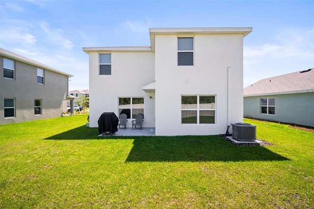 3108 Rock Sound St, Bradenton, FL 34208 - back of property with central air condition unit, a yard, stucco siding, and a patio area