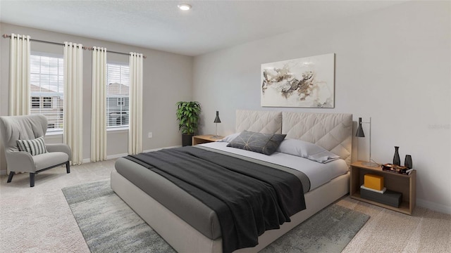 bedroom featuring light colored carpet and baseboards