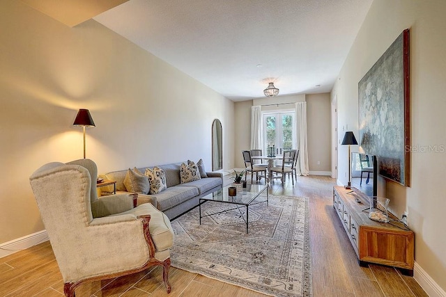 living room featuring baseboards and wood finished floors