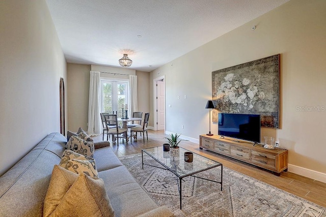 living room with wood finished floors and baseboards