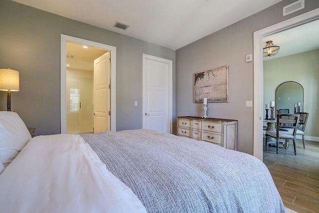 bedroom with wood finished floors and baseboards