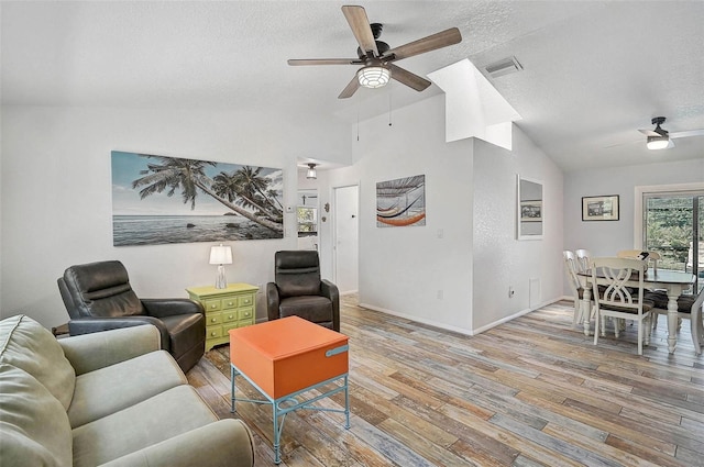 2127 Corfell St, Port Charlotte, FL 33948 - living area with a ceiling fan, vaulted ceiling, wood finished floors, a textured ceiling, and baseboards