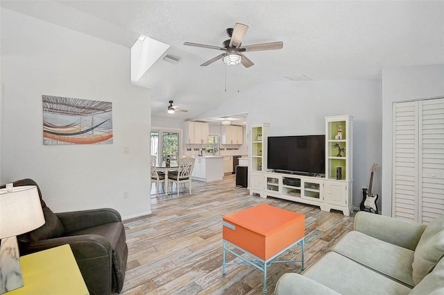 2127 Corfell St, Port Charlotte, FL 33948 - living room featuring a ceiling fan, light wood-style flooring, lofted ceiling, and baseboards