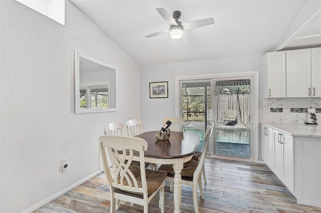 2127 Corfell St, Port Charlotte, FL 33948 - dining area with plenty of natural light, light wood-style flooring, vaulted ceiling, a textured wall, and ceiling fan