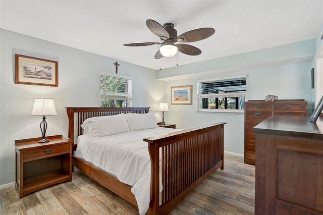 2127 Corfell St, Port Charlotte, FL 33948 - bedroom with wood finished floors, baseboards, and a ceiling fan