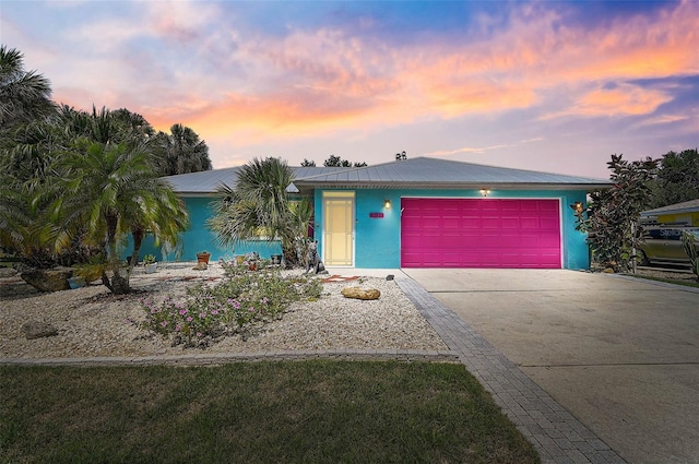 2127 Corfell St, Port Charlotte, FL 33948 - view of front facade featuring driveway, an attached garage, and stucco siding