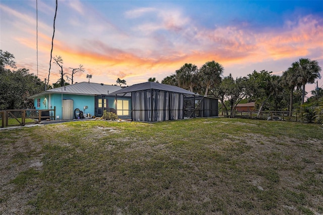 2127 Corfell St, Port Charlotte, FL 33948 - back of house at dusk featuring a lanai